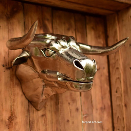 Bull's head - forged sculpture in polished stainless steel